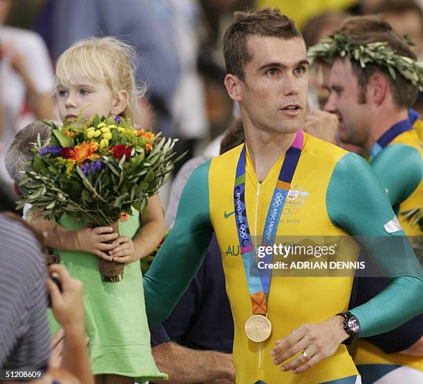 Gold medalllist Australian Bradley McGee celebrates his team's victory with his daughter Tahlia at the end of the men's team pursuit finals at the...