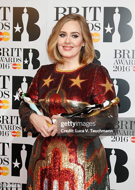 Adele poses in the winners room at the BRIT Awards 2016 with her 4 Brit awards at The O2 Arena on February 24, 2016 in London, England.