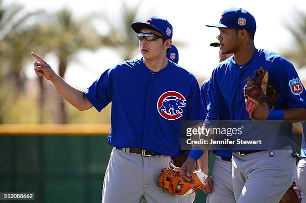 Infielder Munenori Kawasaki of the Chicago Cubs points alongside Addison Russell during a spring training workout at Sloan Park on February 24, 2016...