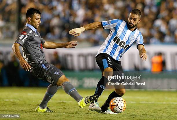 Lisandro Lopez of Racing Club fights for the ball with Danny Bejarano of Bolivar during a group stage match between Racing Club and Bolivar as part...