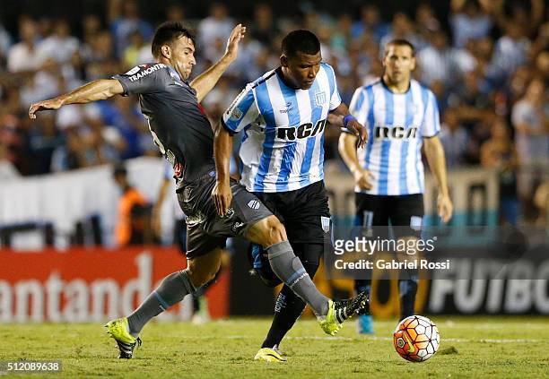 Roger Martinez of Racing Club fights for the ball with Danny Bejarano of Bolivar during a group stage match between Racing Club and Bolivar as part...