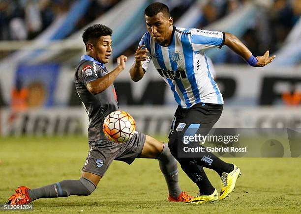 Roger Martinez of Racing Club fights for the ball with Erwin Saavedra of Bolivar during a group stage match between Racing Club and Bolivar as part...