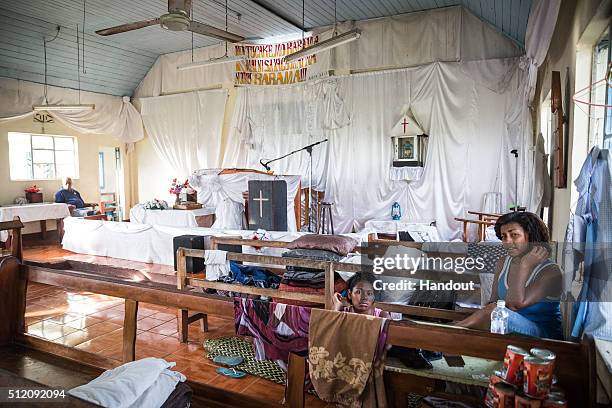 In this handout image supplied by the UNICEF, Micola and Lusiana, 17 sit in an evacuation centre in Ra Province, Viti Levu Island on February 24,...