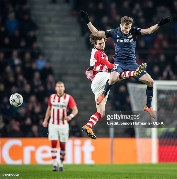 Saul Niguez of Madrid jumps for a header with Davy Proepper of Eindhoven during the UEFA Champions League Round of 16 First Leg match between PSV...