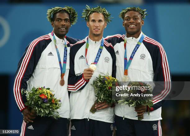 Gold medalist Jeremy Wariner of USA, silver medalist Otis Harris of USA and bronze medalist Derrick Brew of USA celebrate on the podium during the...