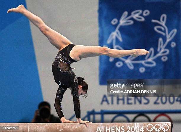 Romania's gold medallist Catalina Ponor performs during the women's beam final, 23 August 2004 at the Olympic Indoor Hall in Athens during the...
