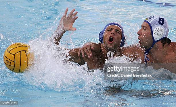 Tamas Kasas of Hungary is fouled by Dmitry Stratan of Russia in the men's Water Polo preliminary game between Russia and Hungary on August 23, 2004...