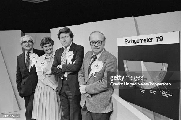 Election presentation team posed beside the swingometer in a BBC television studio set in preparation for an upcoming election coverage programme on...