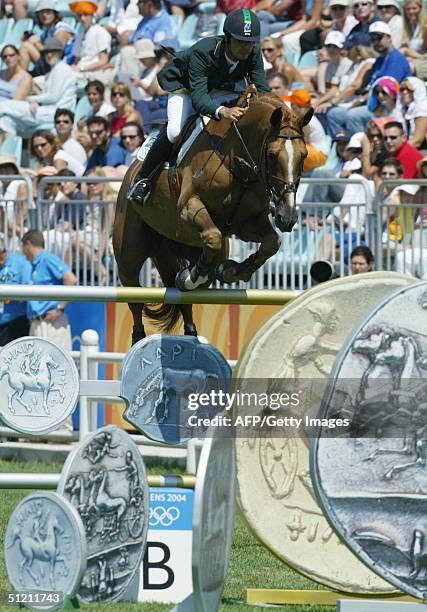 Brazilian jumping rider Rodrigo Pessoa jumps the medal-fence on his horse "Baloubet Du Rouet" 24 August 2004 at the Markopoulo Olympic Equestrian...
