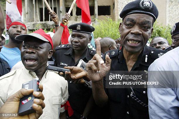 President of Nigeria's Labour Congress Adams Oshiomhole is warned by Police Commissioner Lawrence Alobi 24 August 2004 not to lead workers to a...