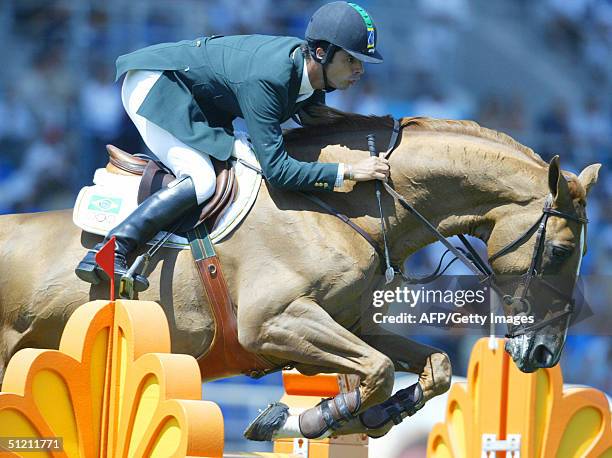 Brazilian jumping rider Rodrigo Pessoa clears a fence on his horse "Baloubet Du Rouet" 24 August 2004 at the Markopoulo Olympic Equestrian Centre in...