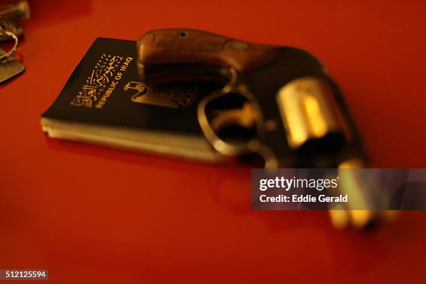 a pistol over iraqi passport - handgun stock pictures, royalty-free photos & images