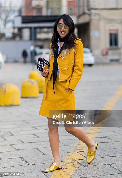 Yuwei Zhangzou wearing a bag from Pierre Hardy, sunglasses from Gentle Monster and golden Gucci shoes seen outside Gucci during Milan Fashion Week...