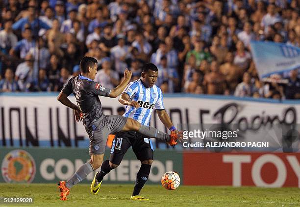 Argentinian Racing Club's forward Roger Martinez vies for the ball with Bolivian Bolivar's defender Gabriel Valverde during their Copa Libertadores...