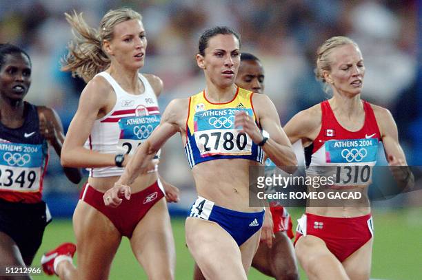 Romania's Maria Cioncan and Canada's Carmen Douma-Hussar compete in the women's 1,500m round 1 at the Olympic Stadium 24 August 2004 during the...