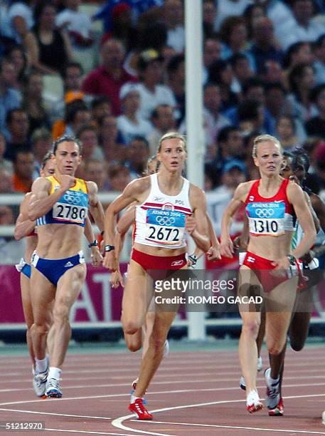 Romania's Maria Cioncan , Poland's Wioletta Janowska and Canada's Carmen Douma-Hussar compete in the women's 1,500m round 1 at the Olympic Stadium 24...