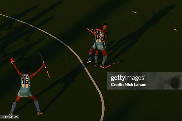 Maria Cecilia Rognomi , Mariana Gonzalez Oliva and Maria Magdalena Aicega of Argentina celebrate after a goal in the women's field hockey semifinals...