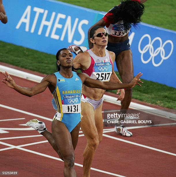 Tonique Williams-Darling of the Bahamas finishes first for the gold in the women's 400m final, ahead of Mexico's Ana Guevara and DeeDee Trotter of...