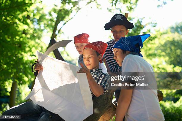 young boys dressed as pirates, reading map - treasure hunt stock pictures, royalty-free photos & images