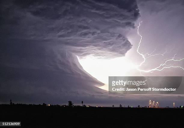 an explosive cloud-to-cloud bolt shoots from this tornadic supercell with highly structured rotation, pampa, texas, usa - storm cloud stockfoto's en -beelden