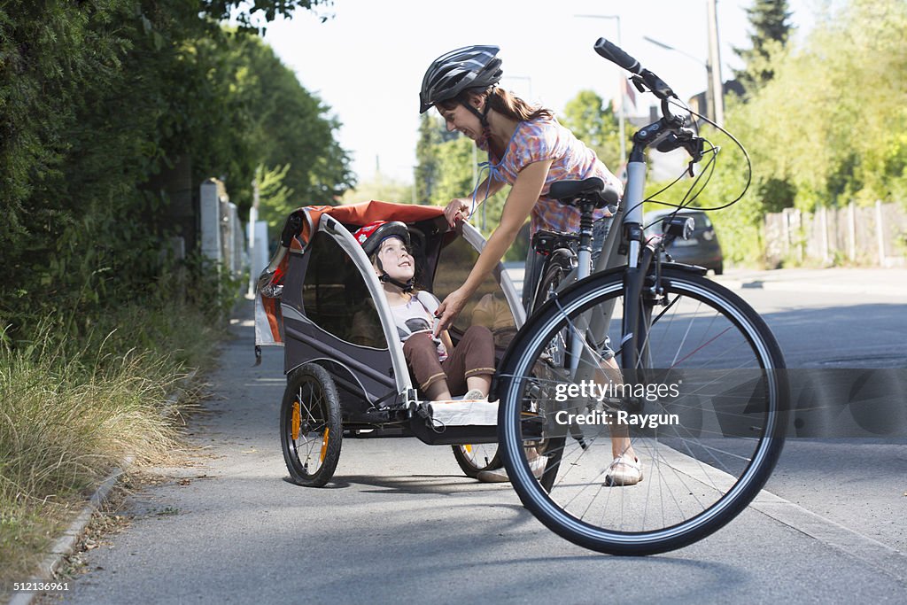 Mother with daughter in bicycle trailer