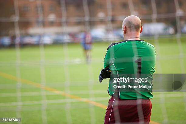 rearview of goalie at football game - amateur football fotografías e imágenes de stock