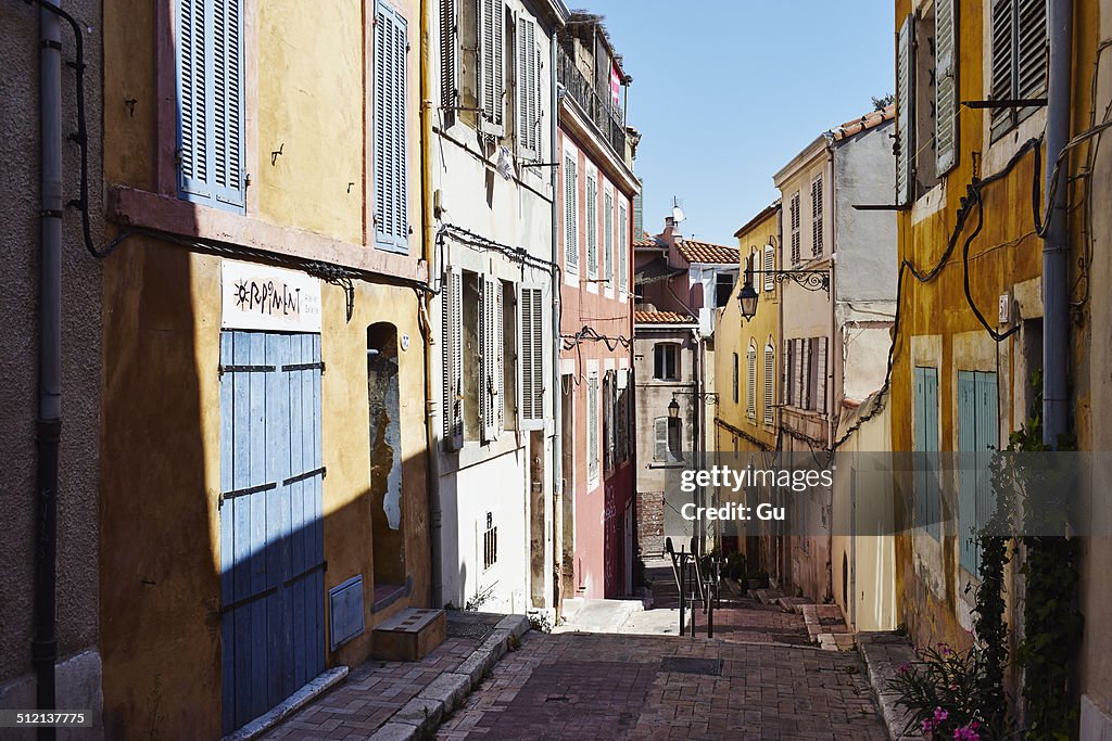 Colorful house exteriors along alleyway, Marseille, France