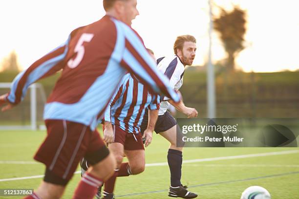 football players running after ball - championship round three imagens e fotografias de stock