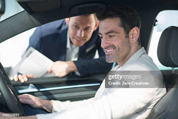 customer trying out new car in car dealership - western cape province stock pictures, royalty-free photos & images