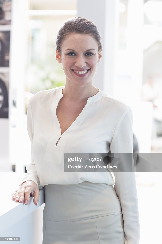 Portrait of saleswoman in car dealership