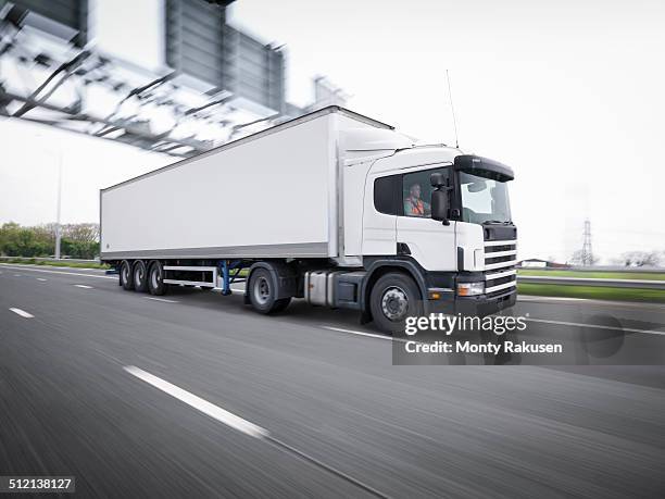 freight truck on the move on motorway - truck england stock-fotos und bilder