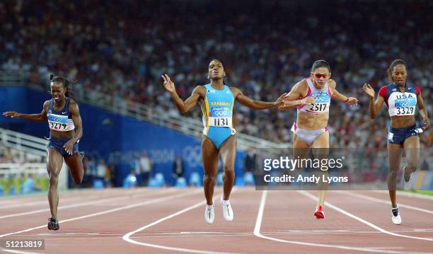 Tonique Williams-Darling of Bahamas crosses the finish line as she win's gold in the women's 400 metre final on August 24, 2004 during the Athens...