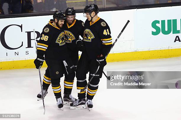 Zac Rinaldo of the Boston Bruins and Joonas Kemppainen congratulate Landon Ferraro after he scored against the Pittsburgh Penguins during the third...