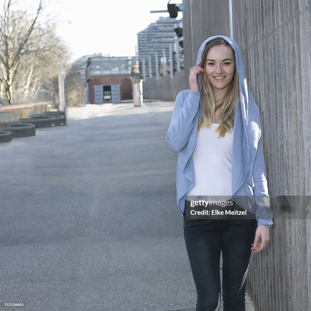 Portrait of young woman wearing hooded top