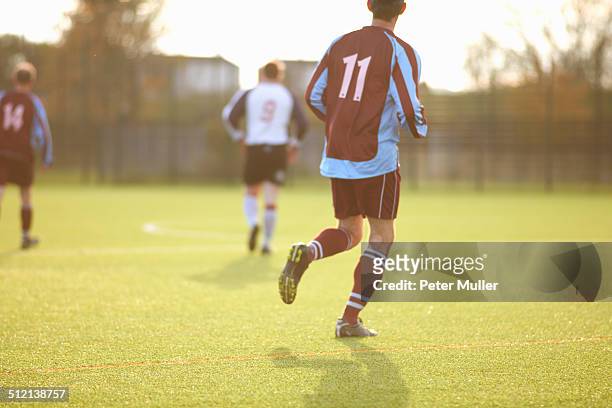 football players during game - sports jersey back stock pictures, royalty-free photos & images