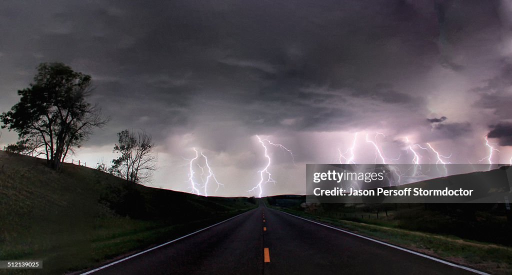 A composite image from 5 images of cloud-to-ground lightening bolts at the end of a rural road, Lexington, Nebraska, USA