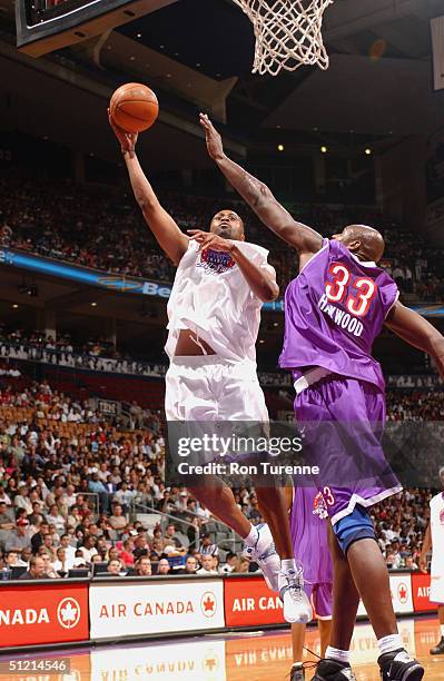Kenny Thomas of the Philadelphia 76ers shoots over Brendan Haywood of the Washington Wizards during the Vince Carter All-Star Charity Game at the Air...