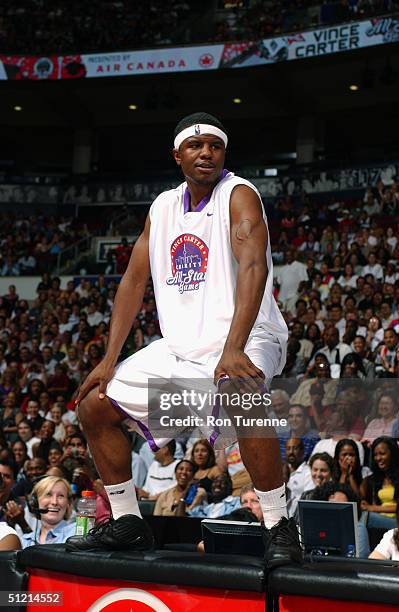 Shammond Williams of the New Orleans Hornets stands on the press table during the Vince Carter All-Star Charity Game at the Air Canada Centre on July...