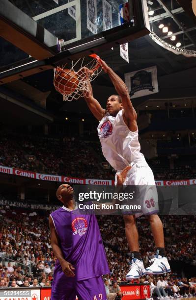Dahntay Jones of the Memphis Grizzlies dunks over Jerry Stackhouse of the Dallas Mavericks during the Vince Carter All-Star Charity Game at the Air...