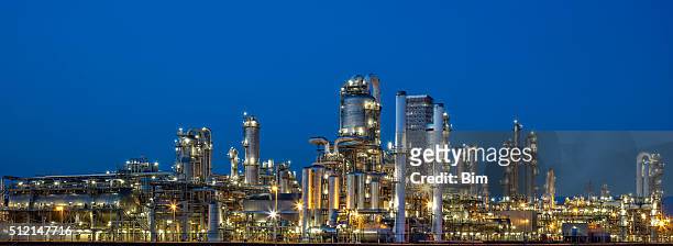 petrochemical plant at dusk - oil refinery stock pictures, royalty-free photos & images