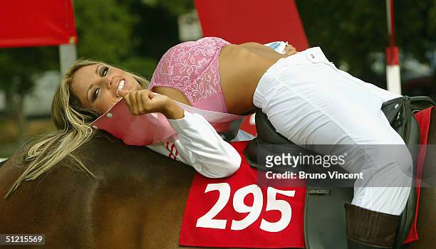 Katie Price - also known as Jordan - poses astride a thoroughbred horse in specially made jockey silks to promote new Sky live entertainment and...
