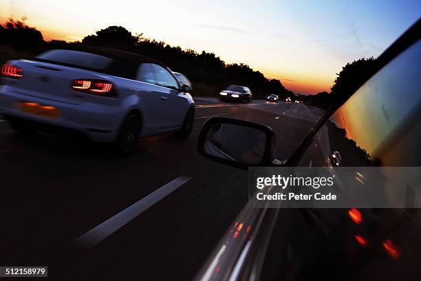 cars on busy road at sunset - overtaking stock pictures, royalty-free photos & images