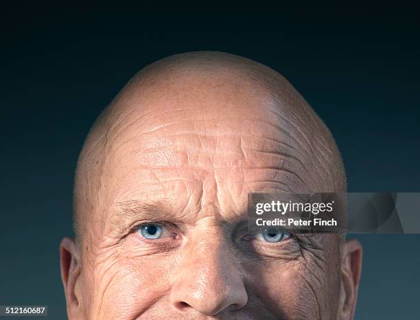 middle-aged man's face with eyes open - vollglatze stock-fotos und bilder