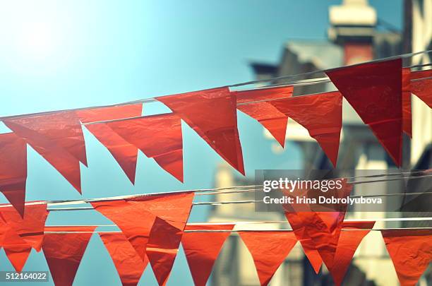 orange flags hanging on typical dutch houses in amsterdam - kingsday ストックフォトと画像