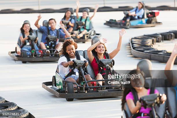 group of teens riding go carts - go carting stock pictures, royalty-free photos & images
