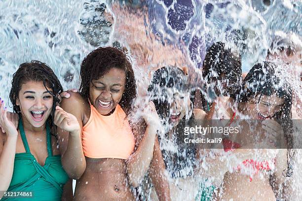 group of teenagers getting soaked at water park - girl looking down stock pictures, royalty-free photos & images