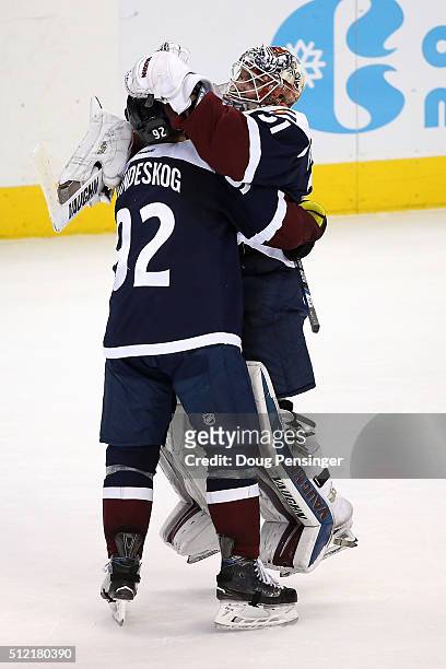 Goalie Calvin Pickard and Gabriel Landeskog of the Colorado Avalanche celebrate their 4-3 overtime shoot out victory over the San Jose Sharks at...