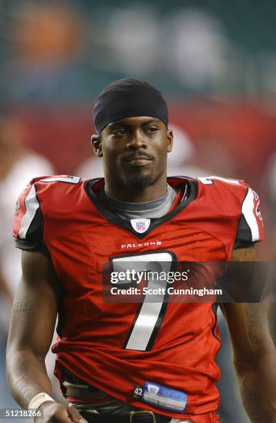 Michael Vick of the Atlanta Falcons looks on from the sideline against the Minnesota Vikings during the preseason NFL game on August 20, 2004 at The...