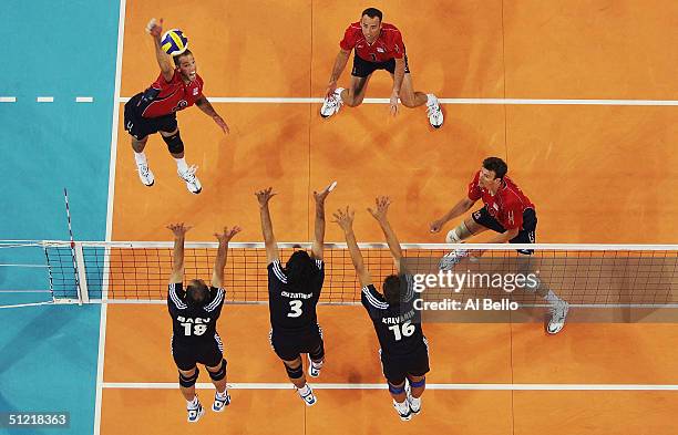 William Priddy of the USA attempts to spike the ball against Greece in the men's indoor Volleyball quarterfinal match on August 25, 2004 during the...