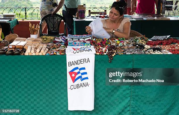 Cuban souvenirs stall. Woman selling from the famous Cuban cigars till T-Shirts with the Cuban flag.